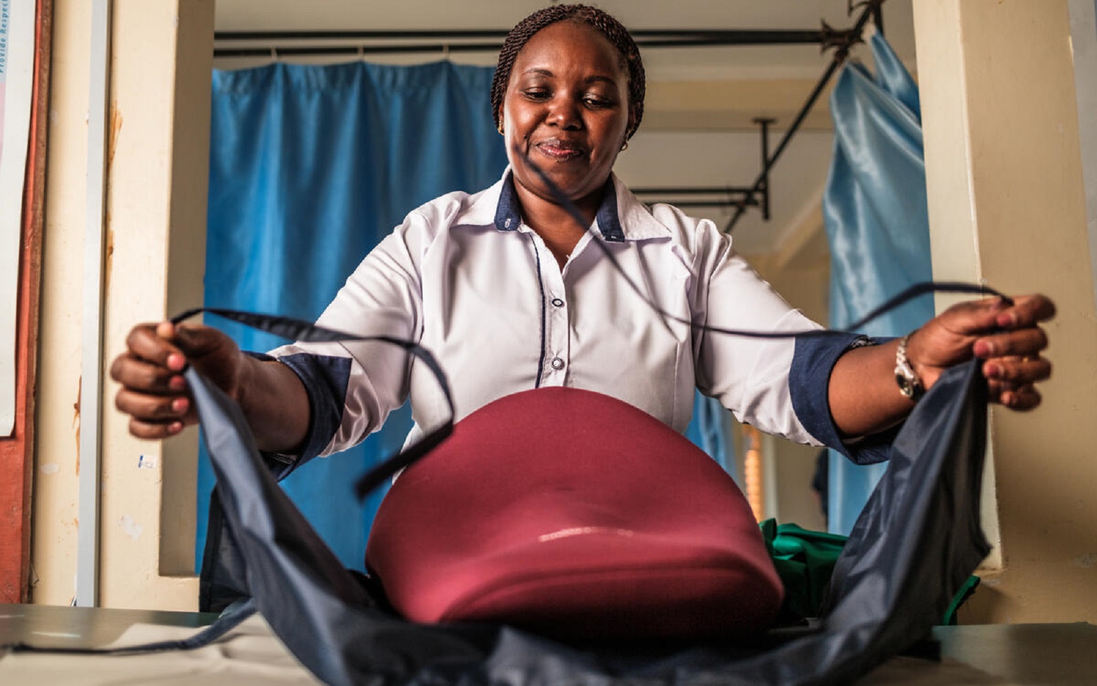 A nurse demonstrates a blood-loss drape used to prevent postpartum hemorrhage